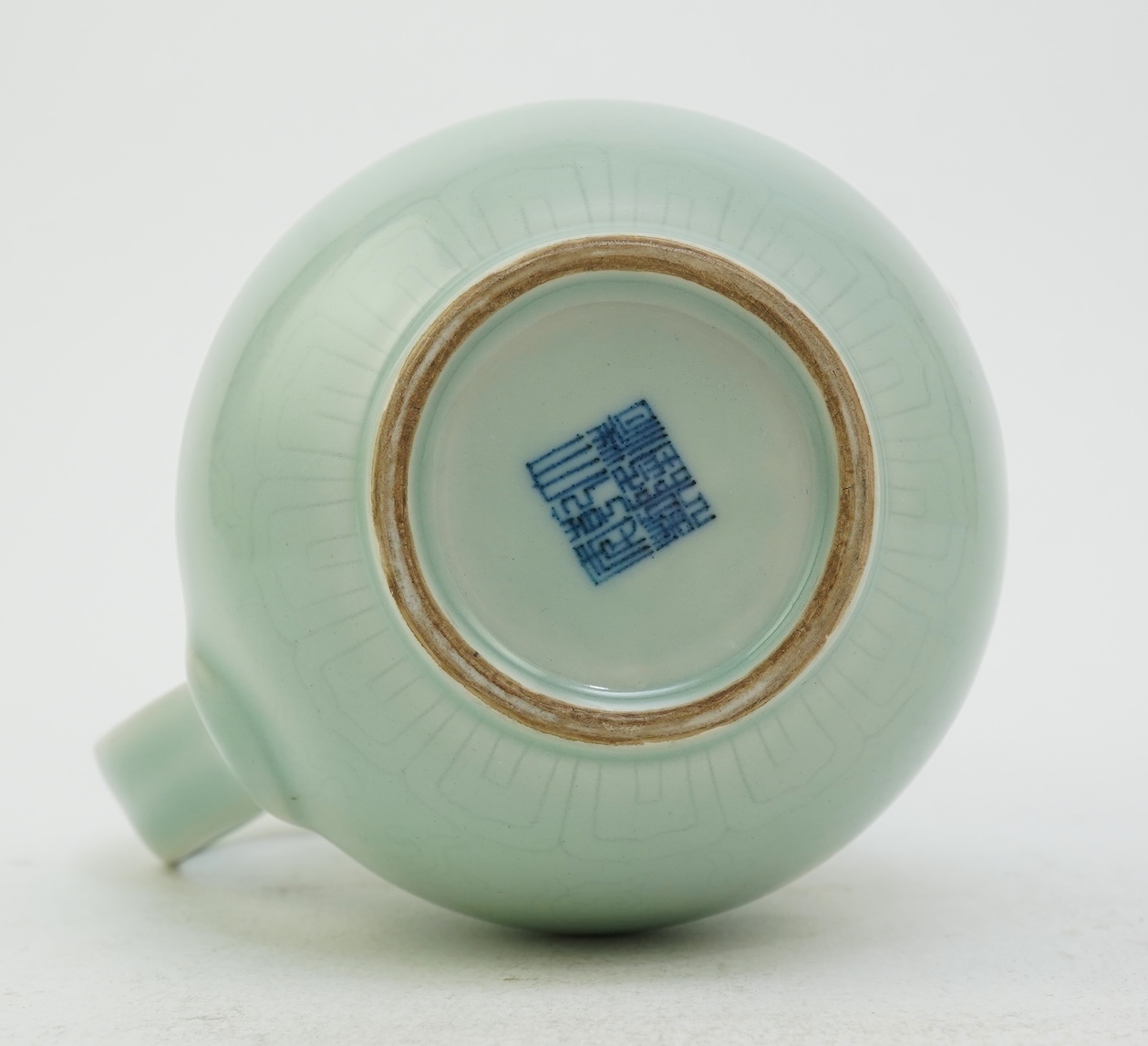 A Chinese incised celadon glazed monks cap ewer, Qianlong seal mark but later, 17cm